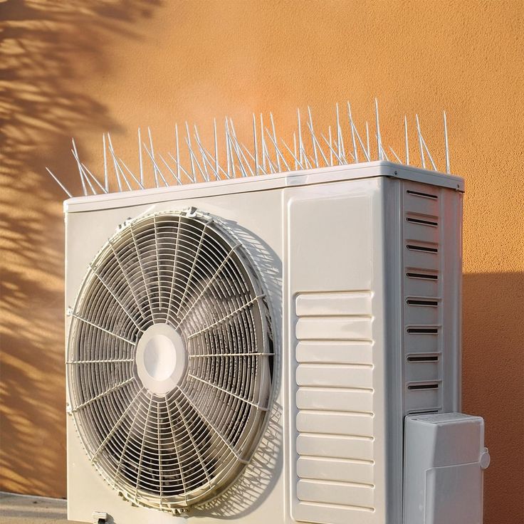 AC unit bird spike frame on apartment building in Mangalore — custom stainless steel spike structure protecting HVAC outdoor units from pigeon nesting