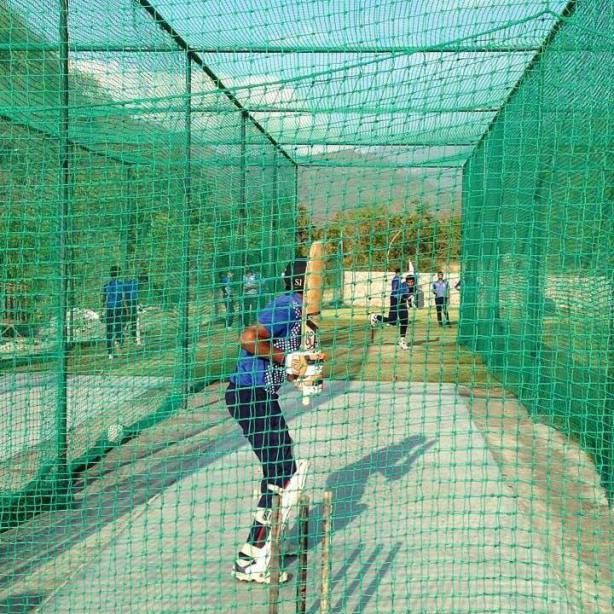 Badminton court boundary netting at school ground in Udupi — side enclosure net preventing shuttlecock loss during outdoor play