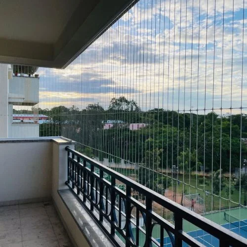 Invisible grills installed on apartment balcony in Andrapradesh — SS316 stainless steel cable grill system with open sea view unobstructed