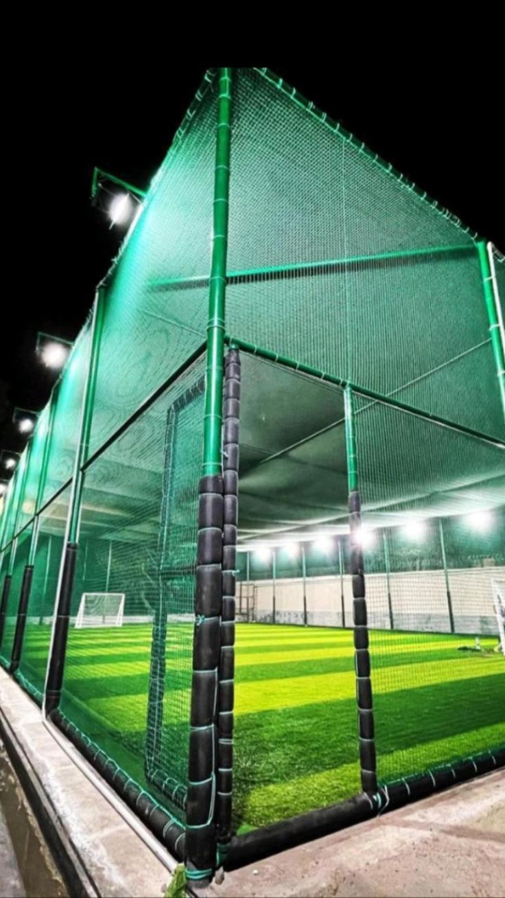 Badminton court boundary netting installed at school in Andrapradesh — side enclosure and back net preventing shuttlecock loss during play