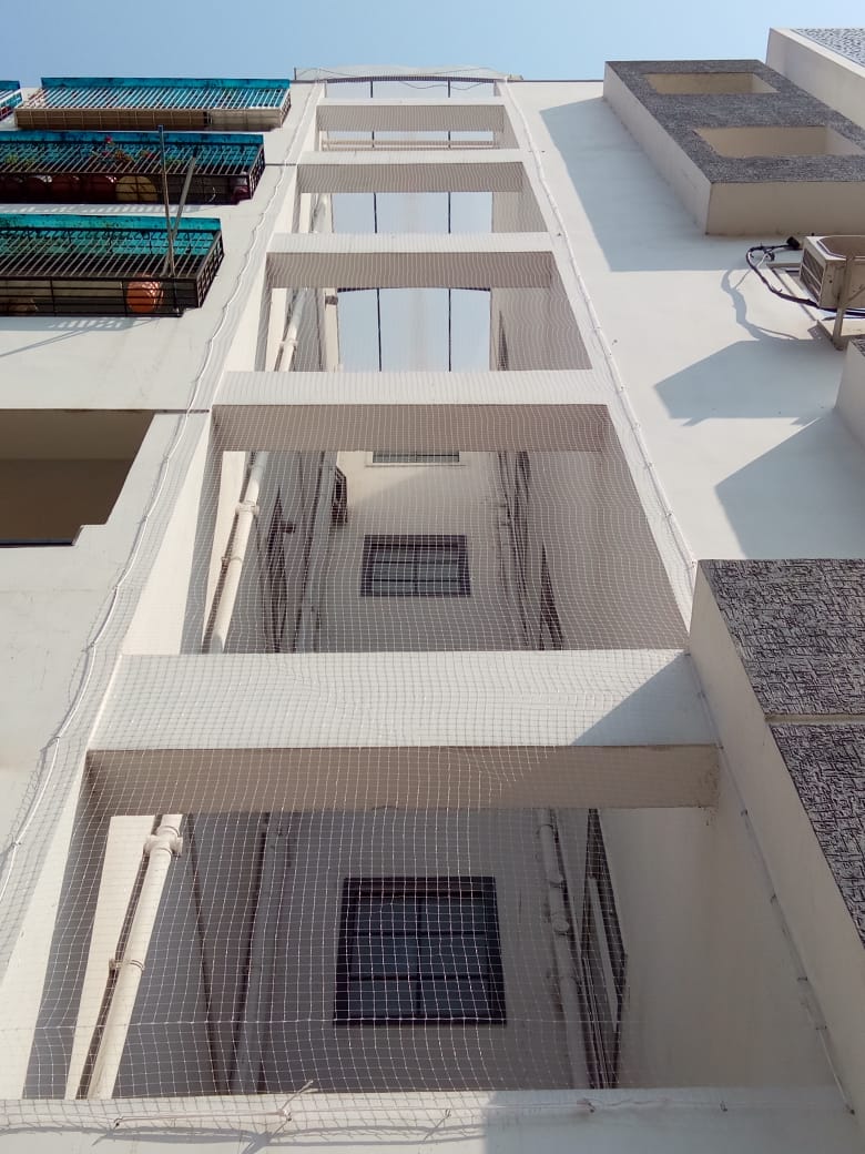 Duct area fine mesh net in apartment complex in Udupi — tight fine mesh installed across AC shaft opening preventing bird entry and nesting