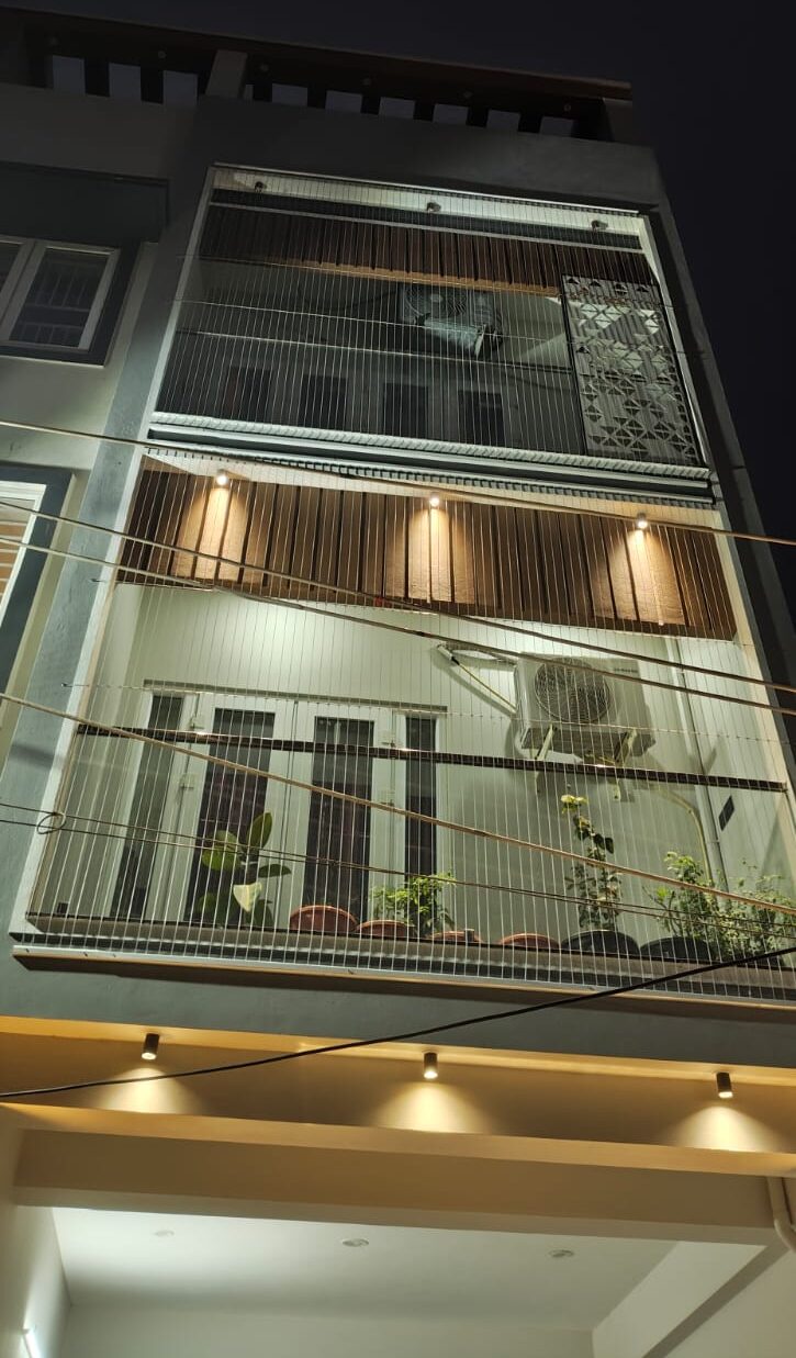 Interior view looking out through invisible cable grills on sea-facing apartment balcony Mangalore — unobstructed ocean view with thin cables in foreground